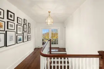 French doors flood the upper and lower hallways with light.