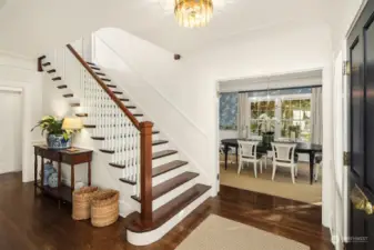 Gracious entry to original curved mahogany and plaster balustrade, plaster relief ceiling medallions, coved ceilings and picture rail and restored white oak floors.