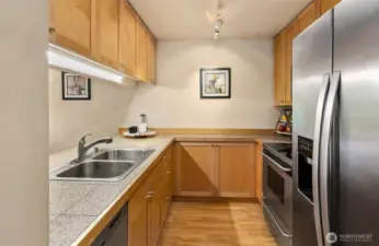 Beautiful kitchen with granite counters, maple cabinets, and stainless steel appliances.