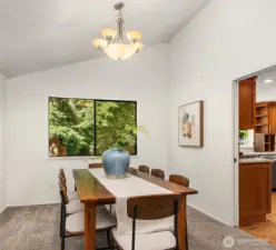 The dining room offers an updated light fixture and views to the backyard.