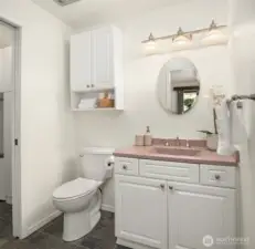 The half bathroom on the main level shares utility/laundry space.
