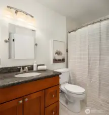 This full bathroom complements the upper level bedrooms. The design is well-appointed.