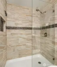 The primary bathroom shower is beautifully appointed.