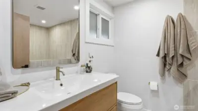 Enjoy a spa-inspired feel in the primary ensuite with its modern updates & soft lighting.