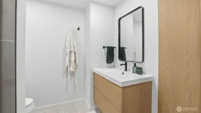 A bright vanity space accented with wood tones and updated modern fixtures.