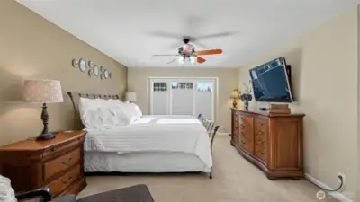 Sunlight, space, and comfort come together in this primary bedroom.