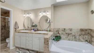 Dual vanities and a soaking tub make this primary ensuite both functional and serene.