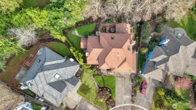 A stunning aerial that highlights the home’s landscaped grounds.
