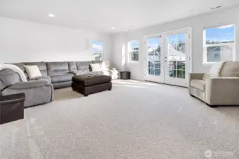 Large bonus/media room with built-in speakers and double doors to juliet balcony.