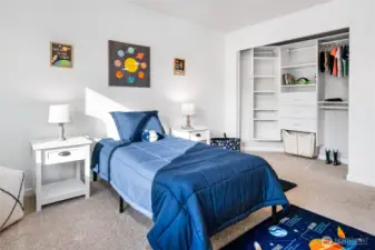 Upper level bedroom with closet built-ins.