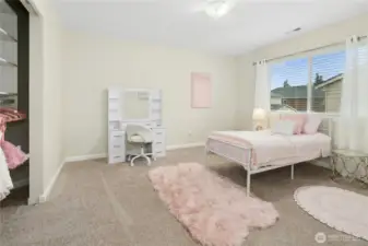 Upper level bedroom with closet built-ins.