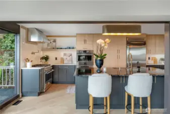 Seating at island, with pop-up outlet in island surface