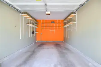 inside of Clean and large individual garage that has shelves