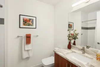 Full tiled guest bath on the upper level.