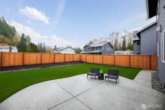 Fully fenced backyard with extended patio