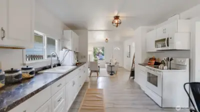 The kitchen shines with freshly painted walls, complementing the spacious layout and offering a bright, welcoming atmosphere throughout the entire home