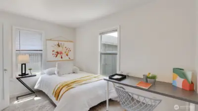 This secondary bedroom offers plenty of natural light and flexible space—perfect for a guest room or a home office