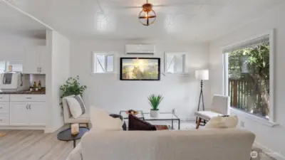 The living room effortlessly flows into the dining area and kitchen, creating an ideal space for gatherings and seamless entertaining
