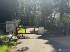This is the community keyed gate to get to the private community beach.  The community rules are posted on the sign to the left.  It's a gorgeous walk or drive to the beach - feels like a park!