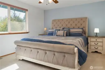 The primary suite’s layout perfectly suits a king-size bed while keeping the room open and airy for a relaxing feel.