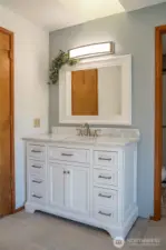 The primary suite sink/vanity featuring plenty of storage.