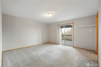 Vast primary bedroom with slider out to deck