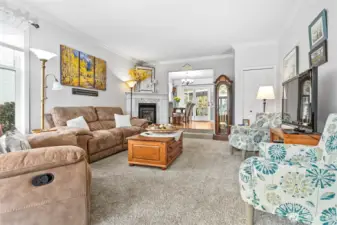 Living room off entry with tons of natural light and a cozy gas FP open to the dining room