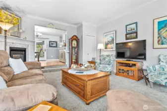 Living room features crown molding and a lovely gas fireplace.  Closet in the corner.