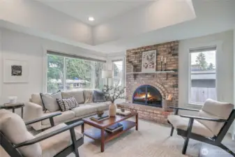 The living room features a beautiful brick fireplace.