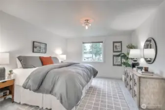 The primary bedroom easily fits a king-size bed, two nightstands and dresser with room to move around.