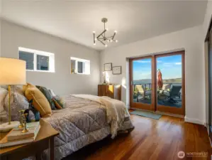 The main floor has two bedrooms. This is the first one with an amazing view of the sound and Fox Island.