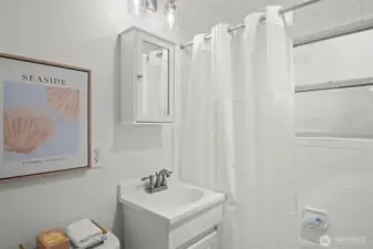 Charming tile bathroom with new vanity & light