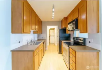Galley kitchen with stainless steel appliances