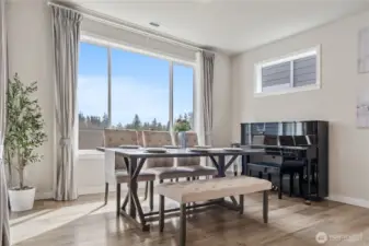 Enjoy the mountain view through the window while dining. Elegant dining area, perfect for hosting, situated between the kitchen and living room.