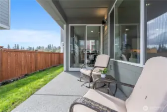 Private, fully fenced backyard with covered outdoor patio area offering a great space for outdoor dining.