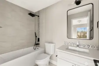 Luxury en-suite bathroom with custom vanity, Quartz counters with Italian tile floors, shower walls and backsplash.