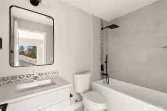 Luxury en-suite bathroom with custom vanity, Quartz counters with Italian tile floors, shower walls and backsplash.