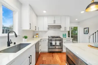 Quartz counters grace this lovely kitchen.  Don't miss the built-in microwave located on the island.