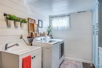 Laundry room w/new cabinets, wall detail, flooring and deep sink. All appliances included.