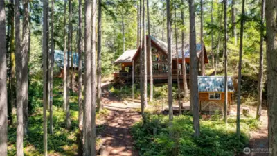 View of home and cordwood cottage