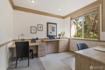 French doors off the foyer lead to the office with 2 maple built-in desks and filing cabinetry.