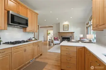 This approximately 1100 sq ft addition includes a living room with vaulted ceiling and slate surround gas fireplace, hardwood floors, an office alcove, kitchenette with bar seating, quartz counters, maple cabinetry, full size refrigerator and 4-burner gas stove and microwave.