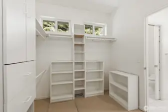 Huge walk-in closet with built-ins connects to the full bathroom.