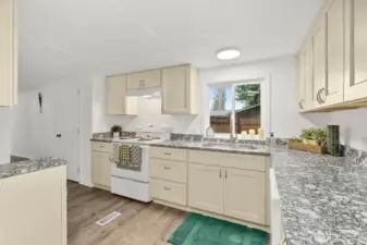 New cabinets and countertops in kitchen.