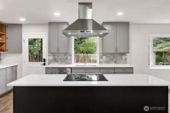 Fully remodeled kitchen with large island/cooktop.