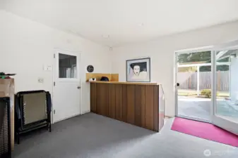 Enjoy this Great room with partial wet bar!  Patio door to backyard.  Left door leads to garage