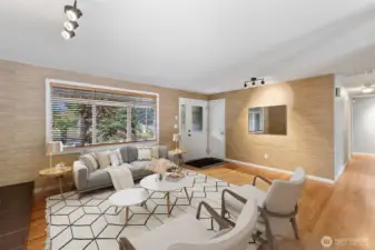 Bright and inviting living room with warm natural textures and expansive front window views.