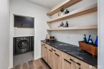 Big walk-in pantry leading to utility room w/quartz slab counters.