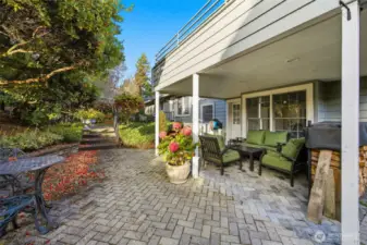 Fully landscaped backyard with mature shrubs and trees