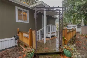 Front entrance to laundry room and kitchen.   Extended deck for warmer days.